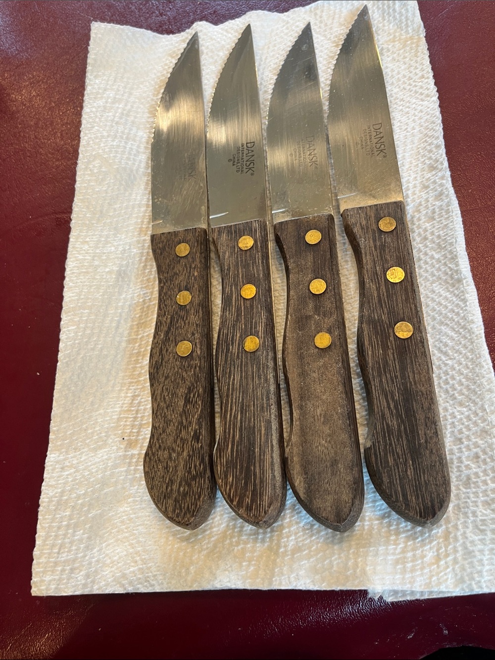 Dansk Four-Piece Steak Knife Set with Brown Wood Handles and Brass Rivets